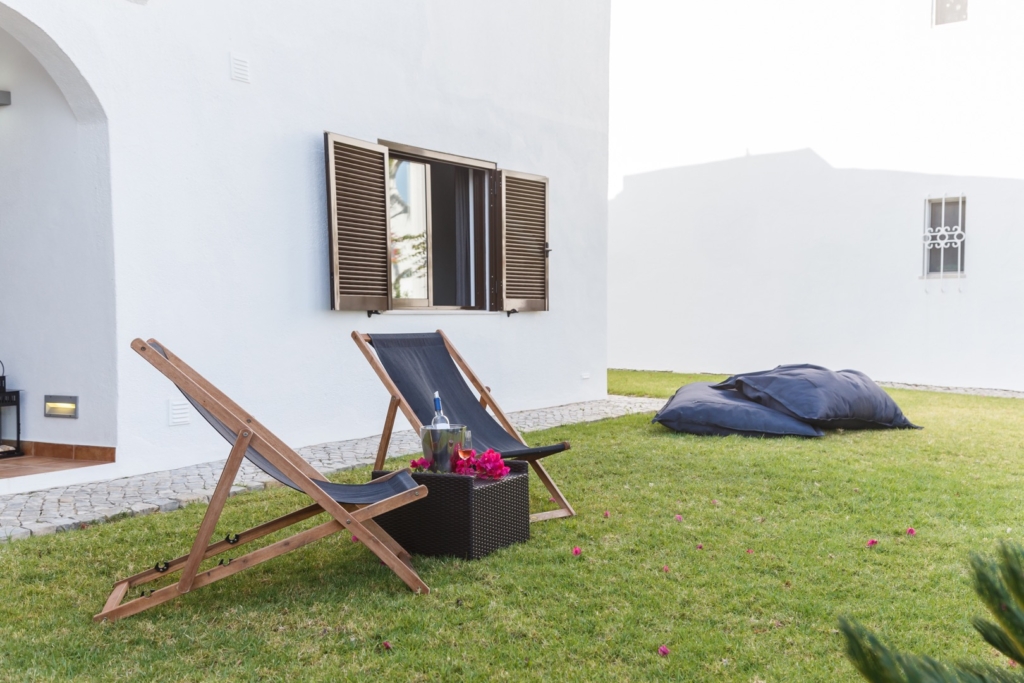 summer apartment garden with chairs and pillows setup